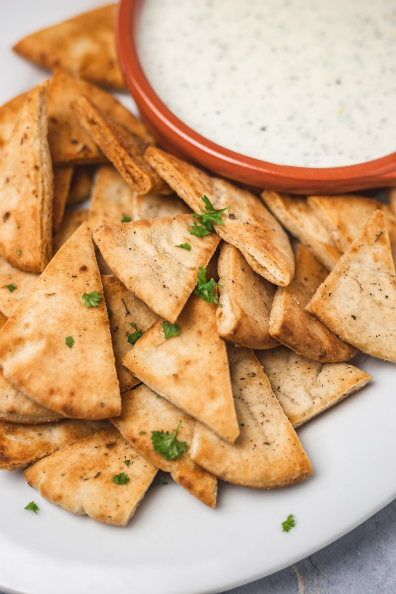 pita chips and dip on a plate.