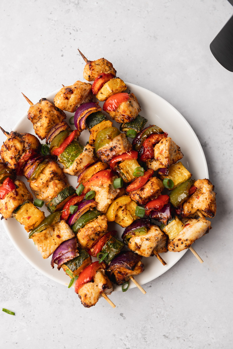 KEBABS ON A WHITE PLATE.