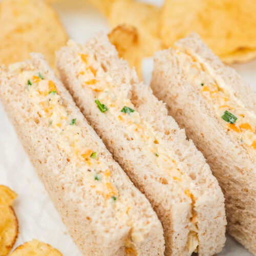 three cheese and onion sandwich fingers on a plate with crisp.