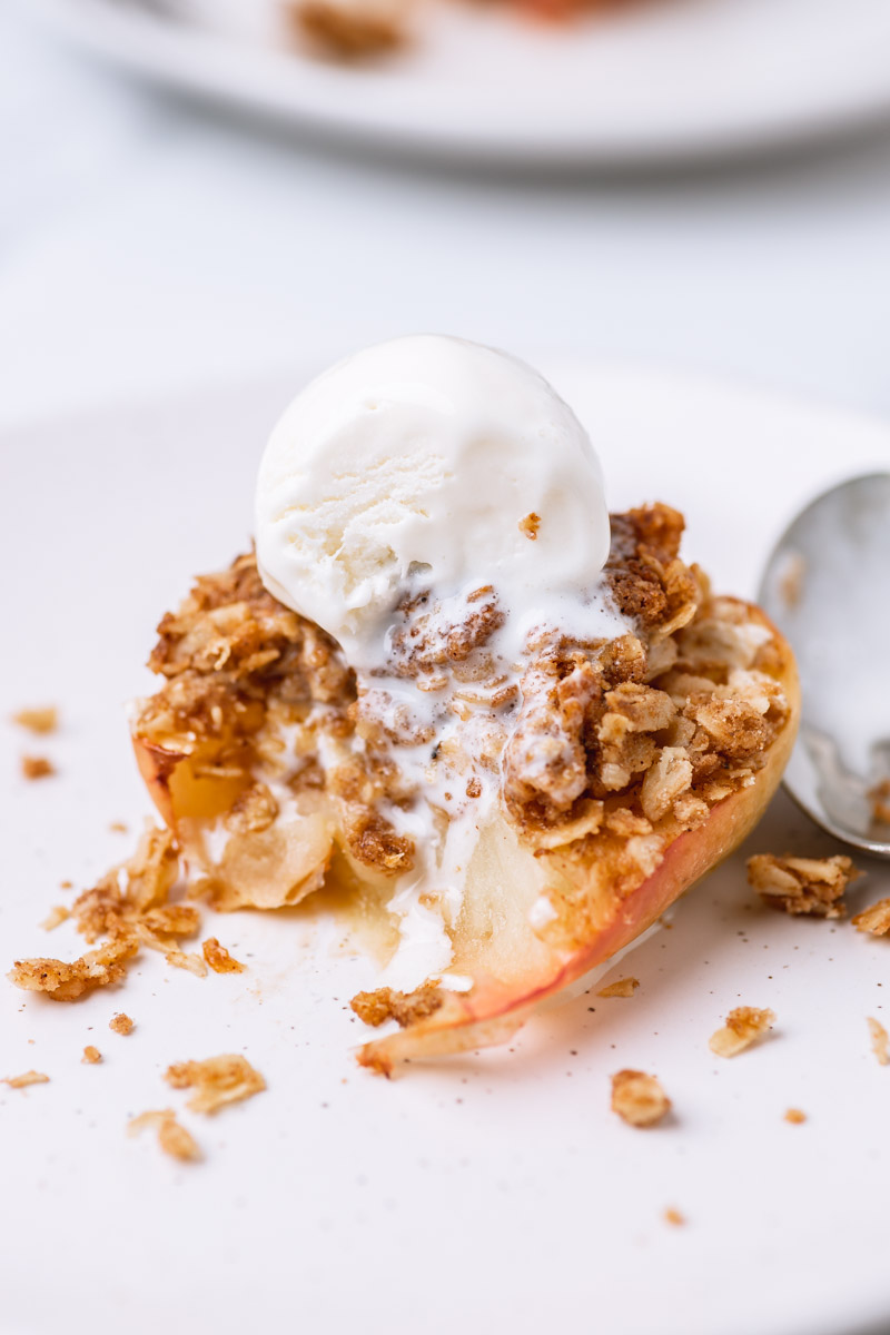 baked apple topped with oat crumble and ice cream.