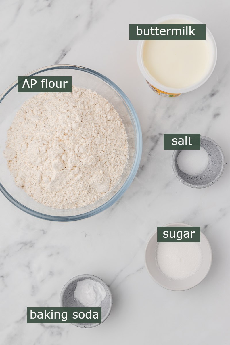 ingredients for making soda bread on a marble surface.