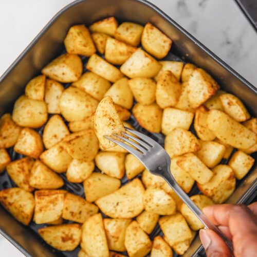 crispy golden brown diced potato on a fork.