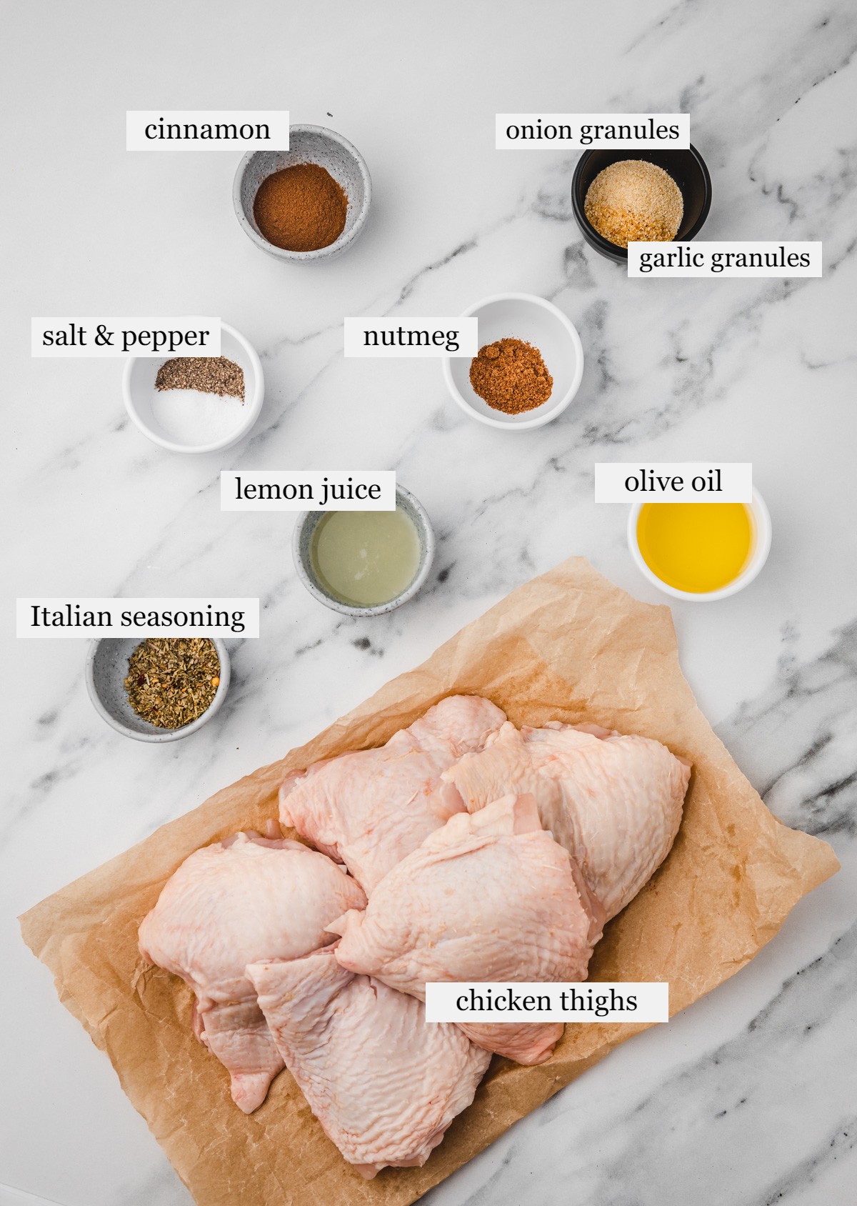 ingredients to make cinnamon chicken on a white marble surface.