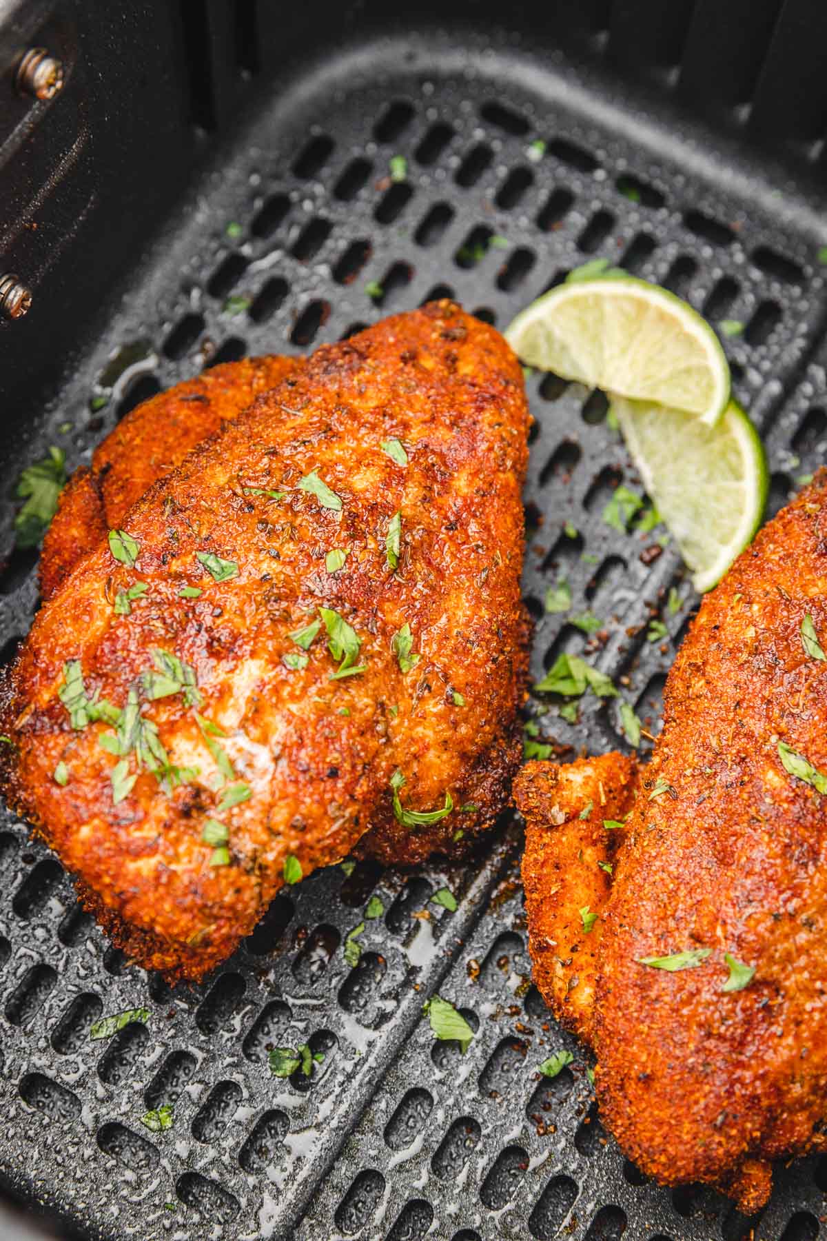 blackened chicken breast and lime wedges.