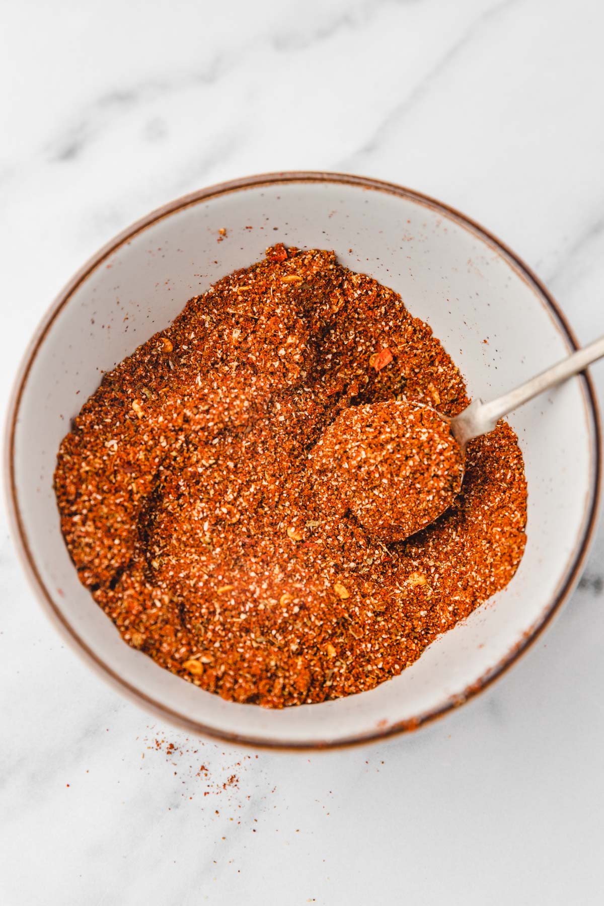 spice mix in a bowl with a spoon.