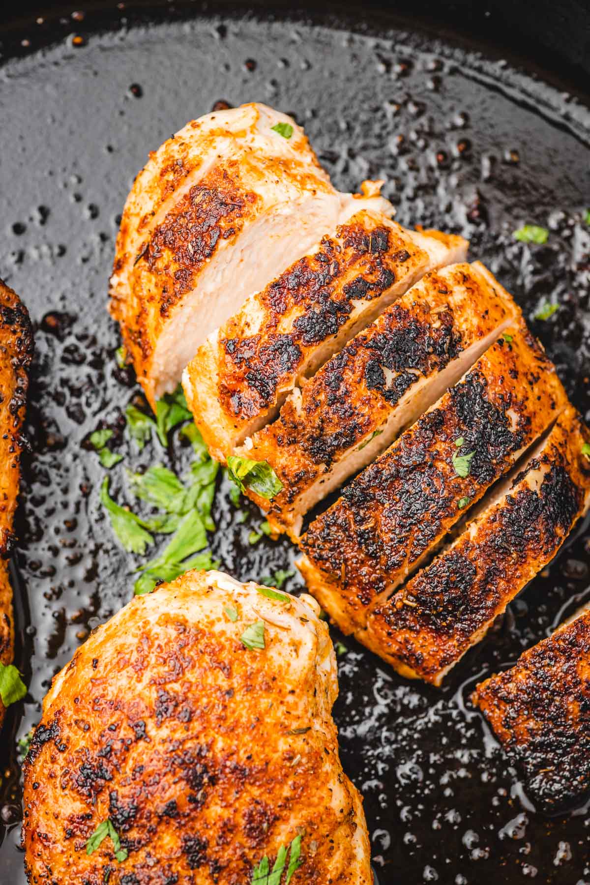 sliced chicken breast in a skillet.