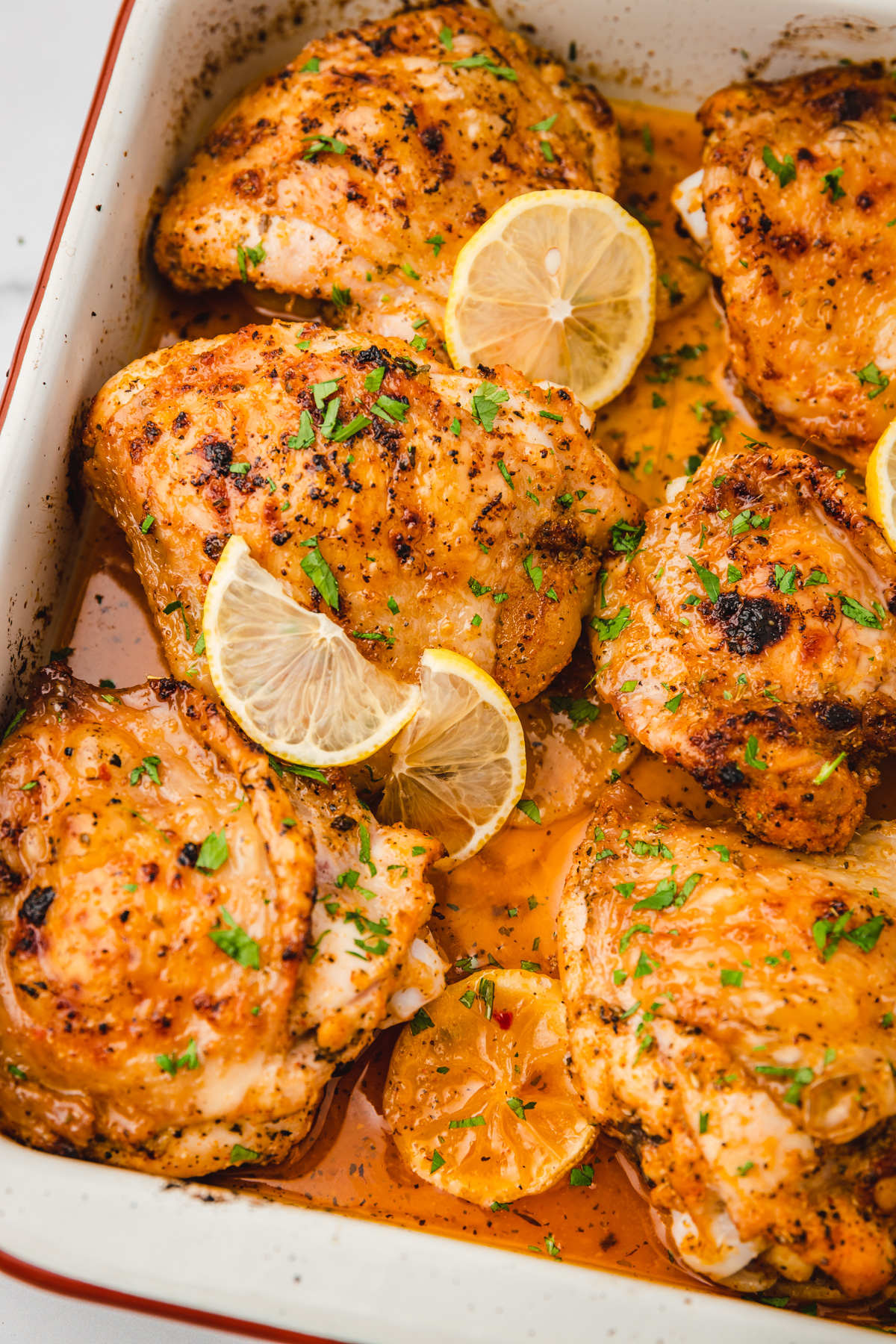 baked lemon chicken thighs in a baking sheet.