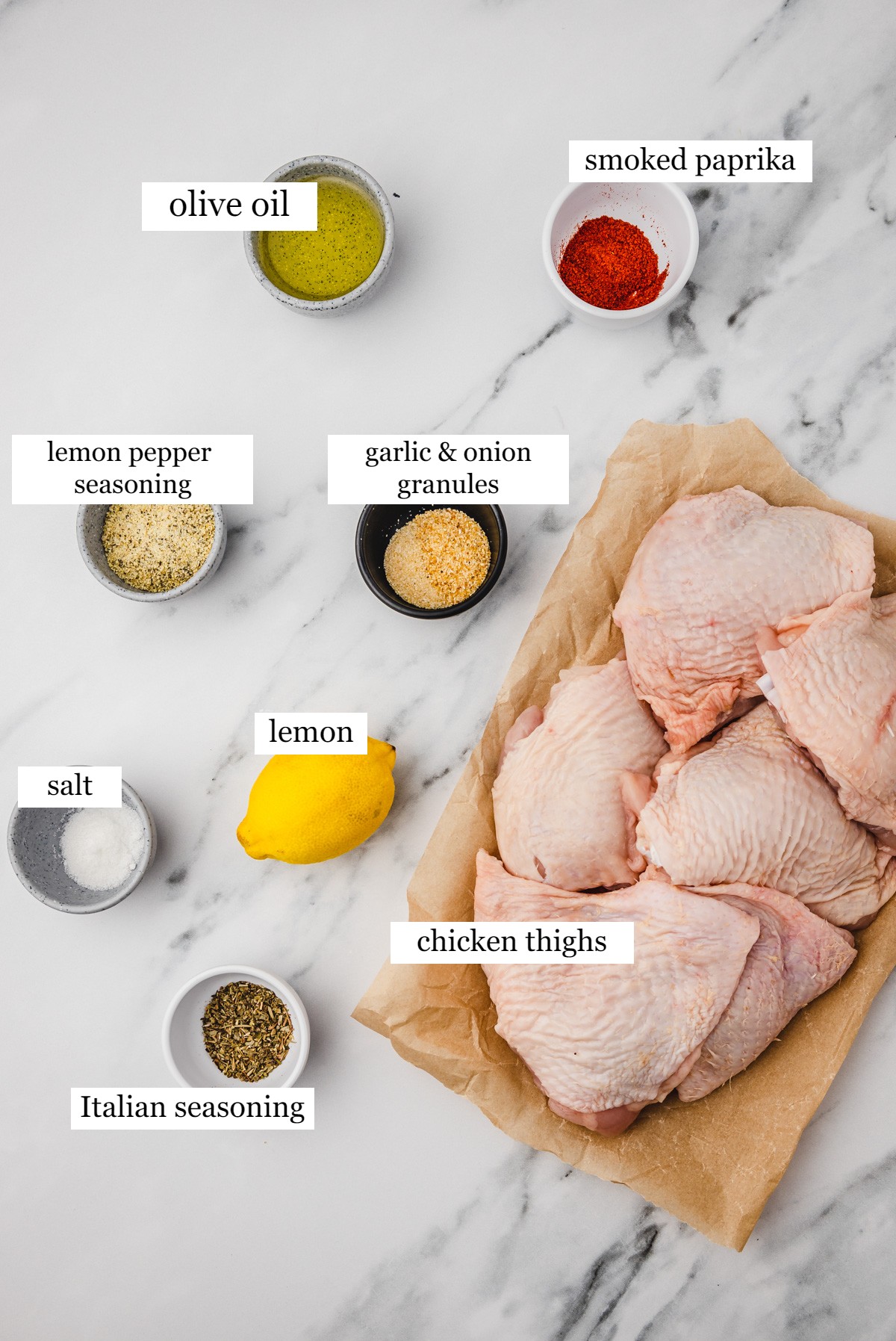 ingredients needed to make lemon pepper seasoning on a white marble surface.