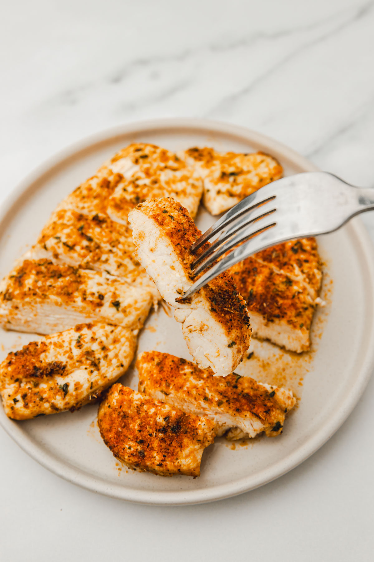 sliced chicken breast on a fork.