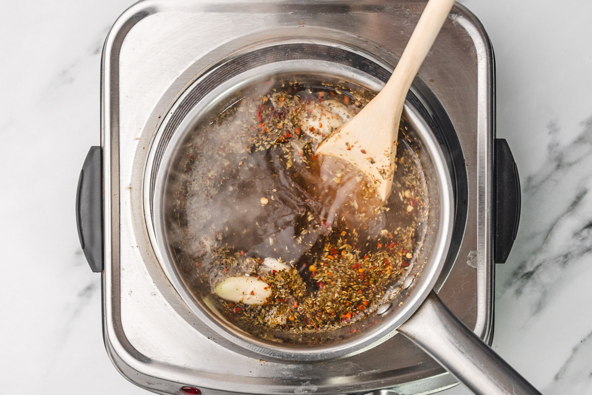brine solution boiling on the stove in a saucepan.