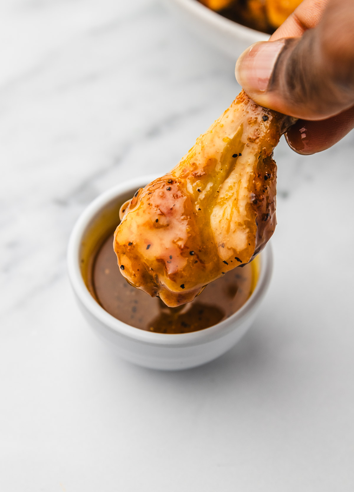 chicken drumettes dipped in a glaze.