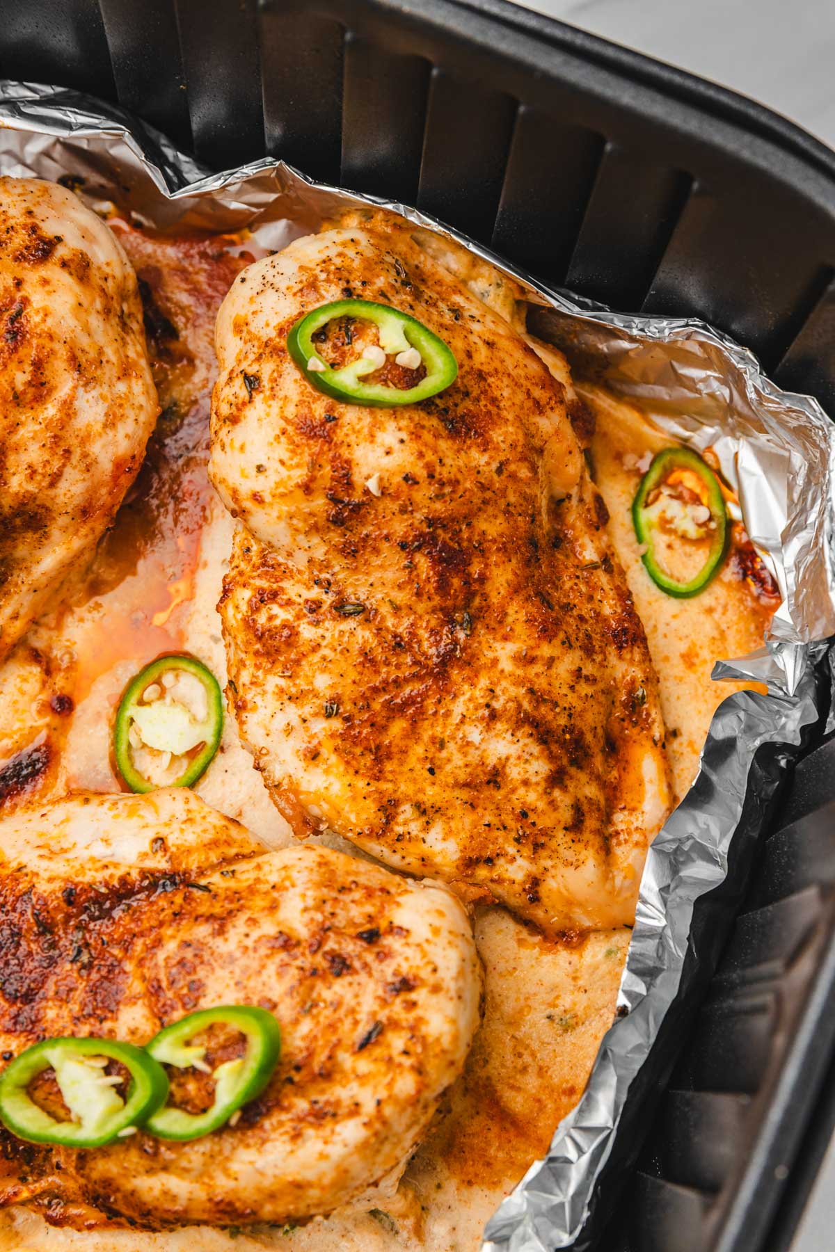 stuffed chicken breast in air fryer basket.