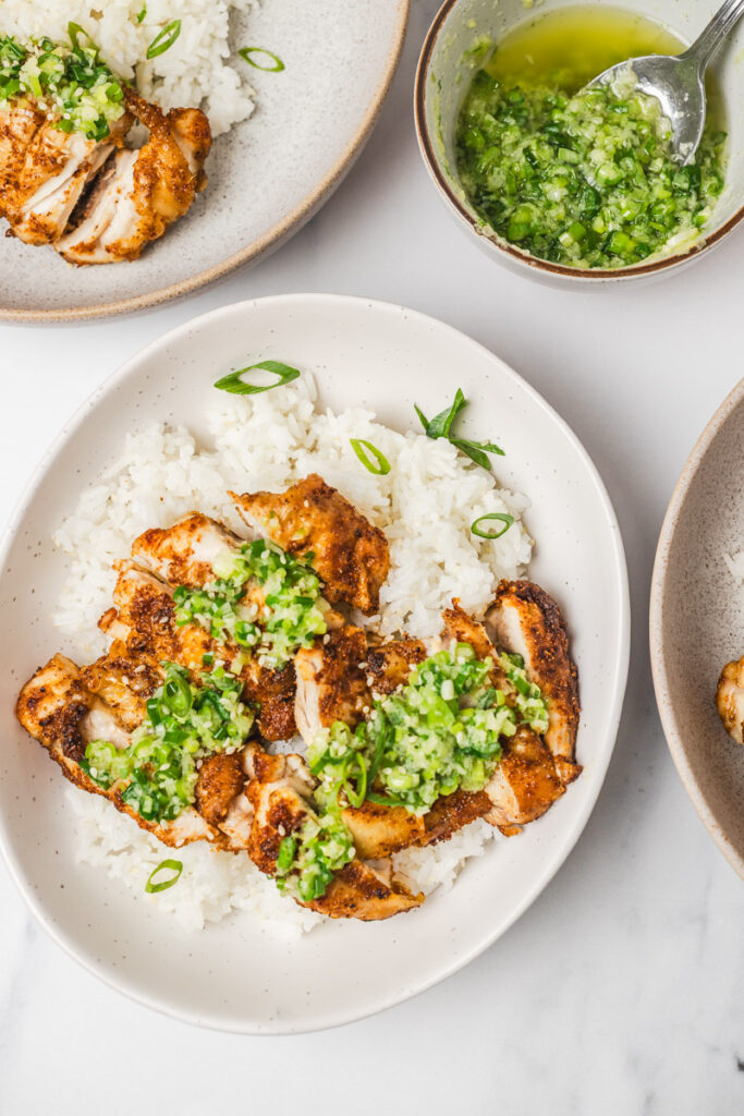 rice bowl with chicken and ginger scallion sauce.