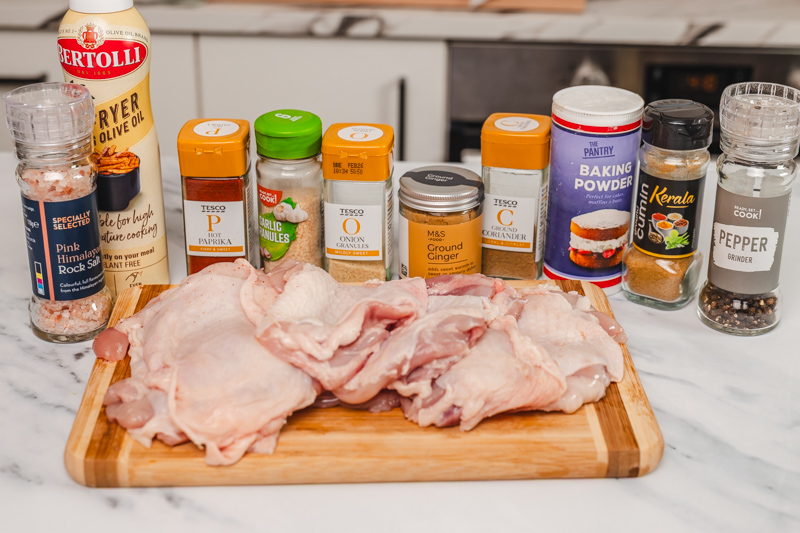 ingredients to cook chicken thighs in on the table.